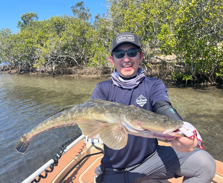 Smiling fisho holding a flathead after catching with a Jackson Puri Ebi Lure