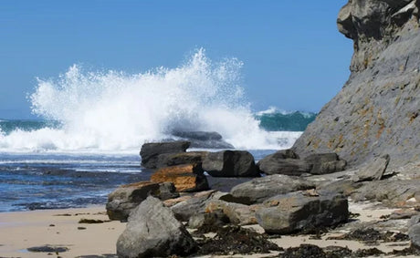 Waves breaking on rocky shore, setting the scene for a beginner's guide to rock fishing with essential tips and techniques