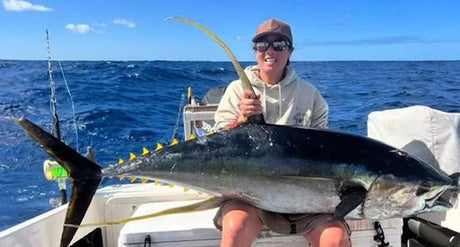 Angler proudly displaying a prize catch in Merimbula, NSW, showcasing the rewards of holiday fishing in Australia