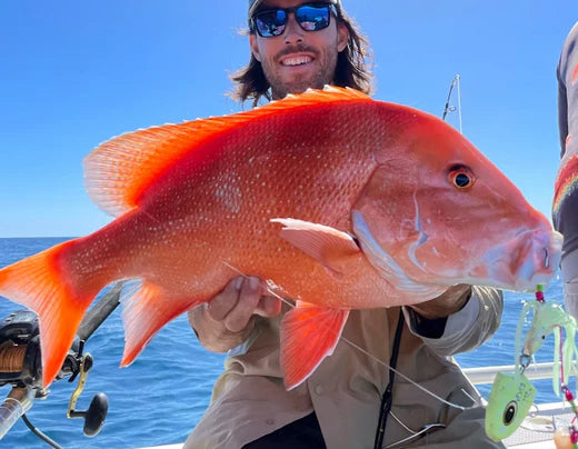 Tackle World expert Gino Chambers holding a Red Emperor fish in Broome, WA, sharing expert tips and techniques for catching this prized species