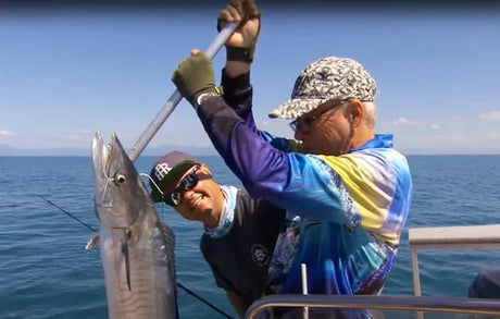 Tackle World Tully expert Roly Newton holding a Wolf Herring, demonstrating effective rigging techniques for targeting this powerful fish species